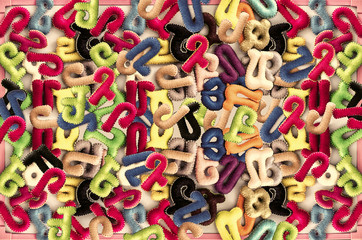 Fototapeta premium Letters of felt fabric for preschool education on a plastic board in a pink frame