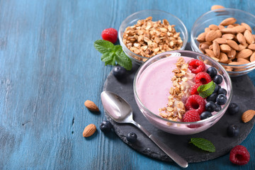 Smoothie bowl, pink smoothie with berries, healthy breakfast, vegan vitamin snack