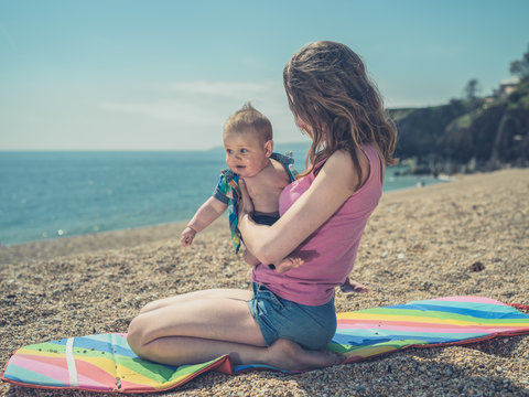Woman with baby on beach