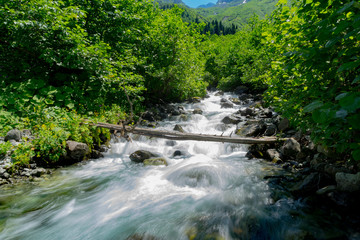 Waterfall in the green valley between the mountains in summer, Gorgit Highland.