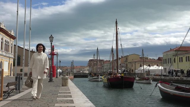 woman coming out of frame shooting Italian port channel