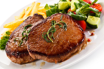 Grilled beefsteak with french fries on white background
