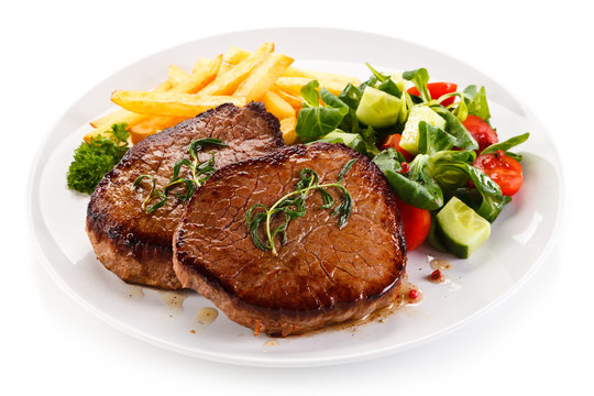 Grilled beefsteak with french fries on white background