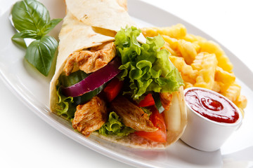 Tortilla wrap with french fries on white background