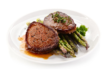 Grilled beefsteak with asparagus on white background