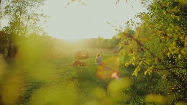 mother and little baby play at sunset. Happy mother with her litte son in forest.