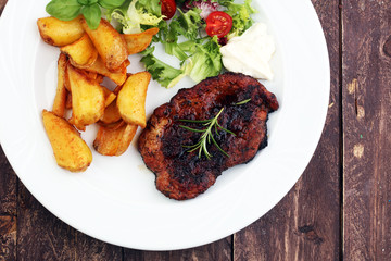 Grilled steaks, baked potatoes and salad