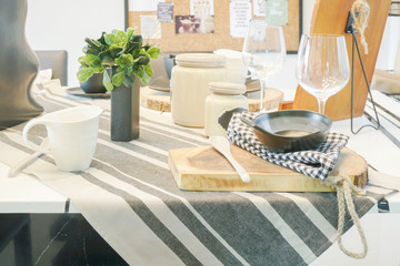 Pottery bowl setting on wooden cutting plate on dining table