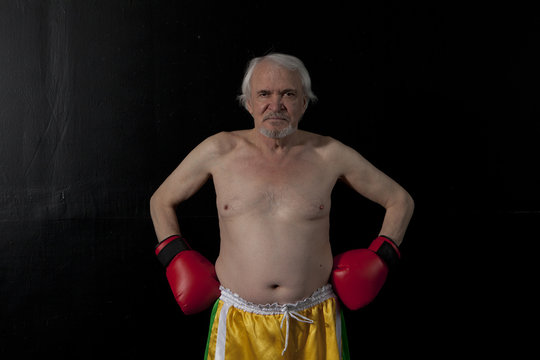 Senior boxer man with red gloves