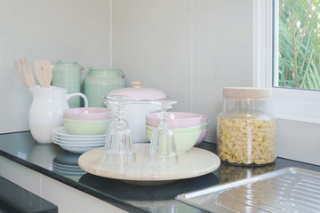 Fototapeta na wymiar Ceramic kitchenware on black granite counter top in the kitchen