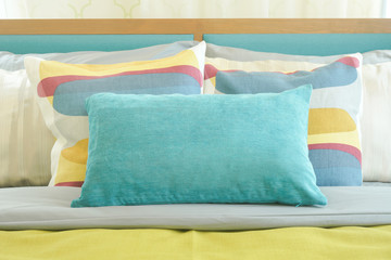 Closeup pillows on bed, yellow and green color scheme bedding