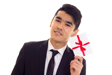 Young man in suit holding a present