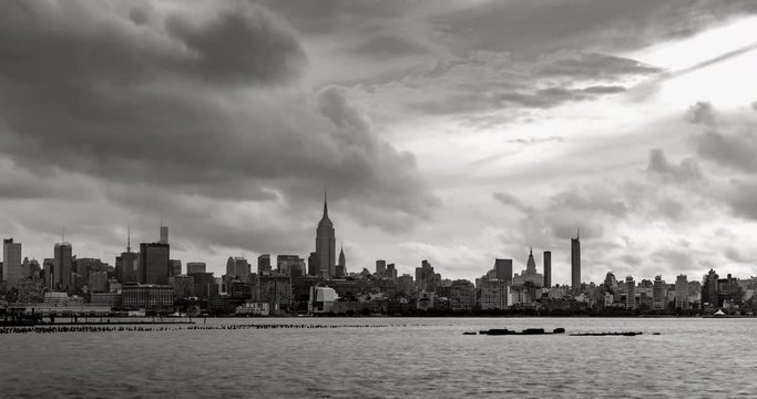 New York City Manhattan Midtown West in early morning with passing clouds. Black & White time lapse includes skyscrapers and views on the West Village (view from Hoboken, New Jersey)