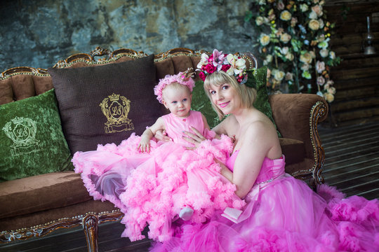 Mom and little daughter in beautiful dresses