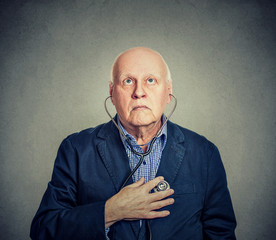 Senior man listening to his heart with stethoscope