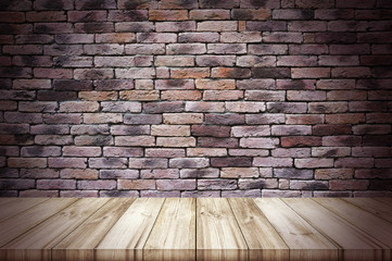 Empty wooden table top with old brick wall background.