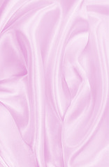 Smooth elegant pink silk or satin texture as wedding background. Luxurious background design