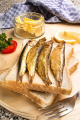 smoked sprats with tomato and lemon