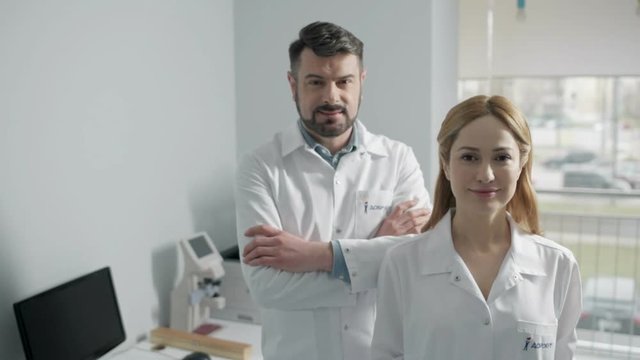 Cheerful doctors standing in office