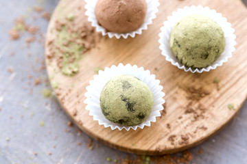 Homemade healthy vegan chocolate truffles rolled cocoa and matcha powder Top view
