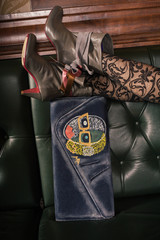 Female fashion closeup of woman legs on handbag
