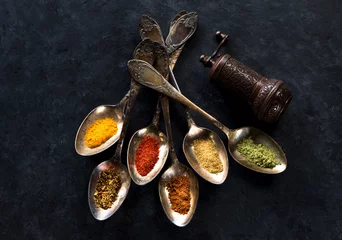 Peel and stick wall murals Aromatic Spices and herbs spoons on a black background
