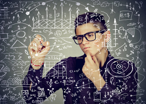 Smart business man writing formulas or science financial calculations