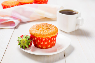 Muffin decorated with strawberry and coffee