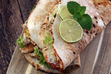 Delicious kebab sandwiches on wooden table