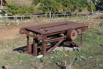 Old and rusty mechanism industry background on the grass