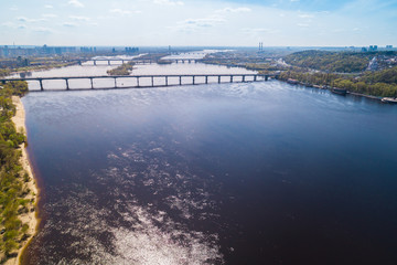 Fototapeta na wymiar Panoramic view of the city of Kiev in the spring. View of the Dnieper River and bridges across it. Aerial view, from above. Outdoor.