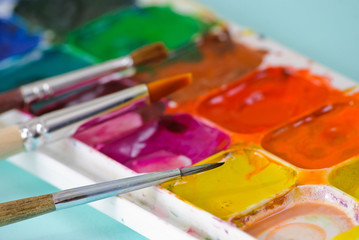 Artist brushes and used palette