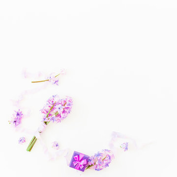 Bouquet of pink hyacinth flowers, ring box and tapes on white background. Flat lay, top view.
