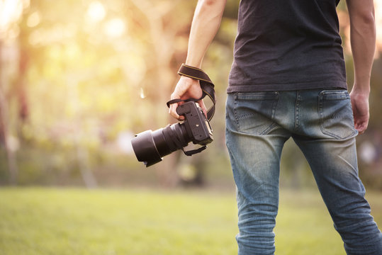 Man is a professional photographer with dslr camera, outdoor and sunlight, Portrait, copy space.