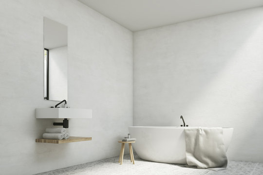 White bathroom with sink and tub