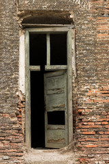 Fototapeta na wymiar A Ruined Wooden Door in the Fortifications of the City of Alba Iulia