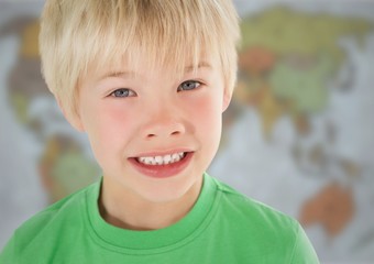 Boy smiling against blurry map
