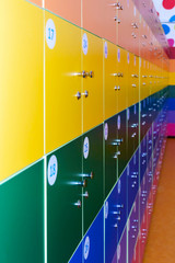The wall is decorated with multi-colored storage chambers. A variant of the interior for children's rooms, shops, gambling halls. Numbered cell storage in a baggage room