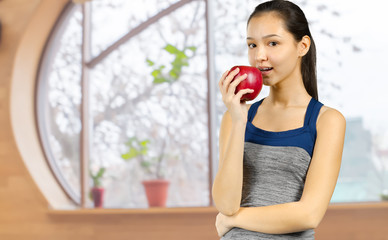 Smiling woman holding red apple