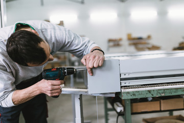 Obraz premium Factory for aluminum and PVC windows and doors production. Manual worker assembling PVC doors and windows. Selective focus. 