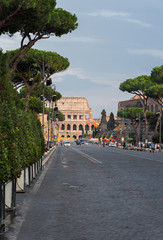 Rome, Italy - September 9  2016: Traffic on the Via dei Fori Imperiali street in front of Colosseum in the evening. Daily life in Rome