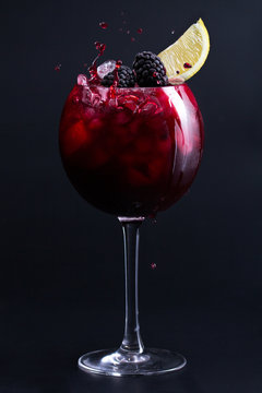 Cocktail. Dark Red Cocktail With Ice, Blackberries And A Slice Of Lemon. Splash