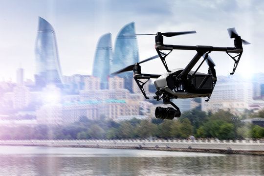 Drone flying over Baku city on blurred background.