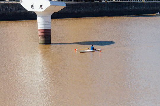 A young man rows in Puerto Madero, Buenos Aires, Argentina