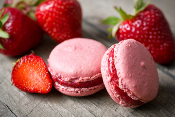 French speciality macaron and a strawberry.