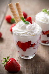 red strawberries with whipped cream dessert.