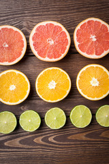 Colorful citrus halves on wooden table. Food background