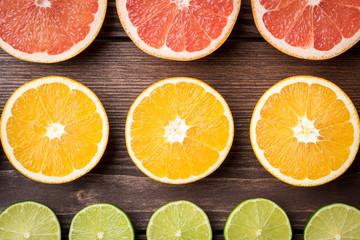 Colorful citrus halves on wooden table. Food background