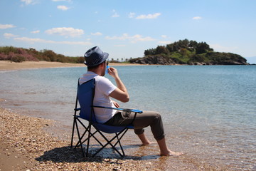 Fototapeta premium a man sitting on the beach