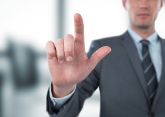 Midsection of businessman gesturing in office